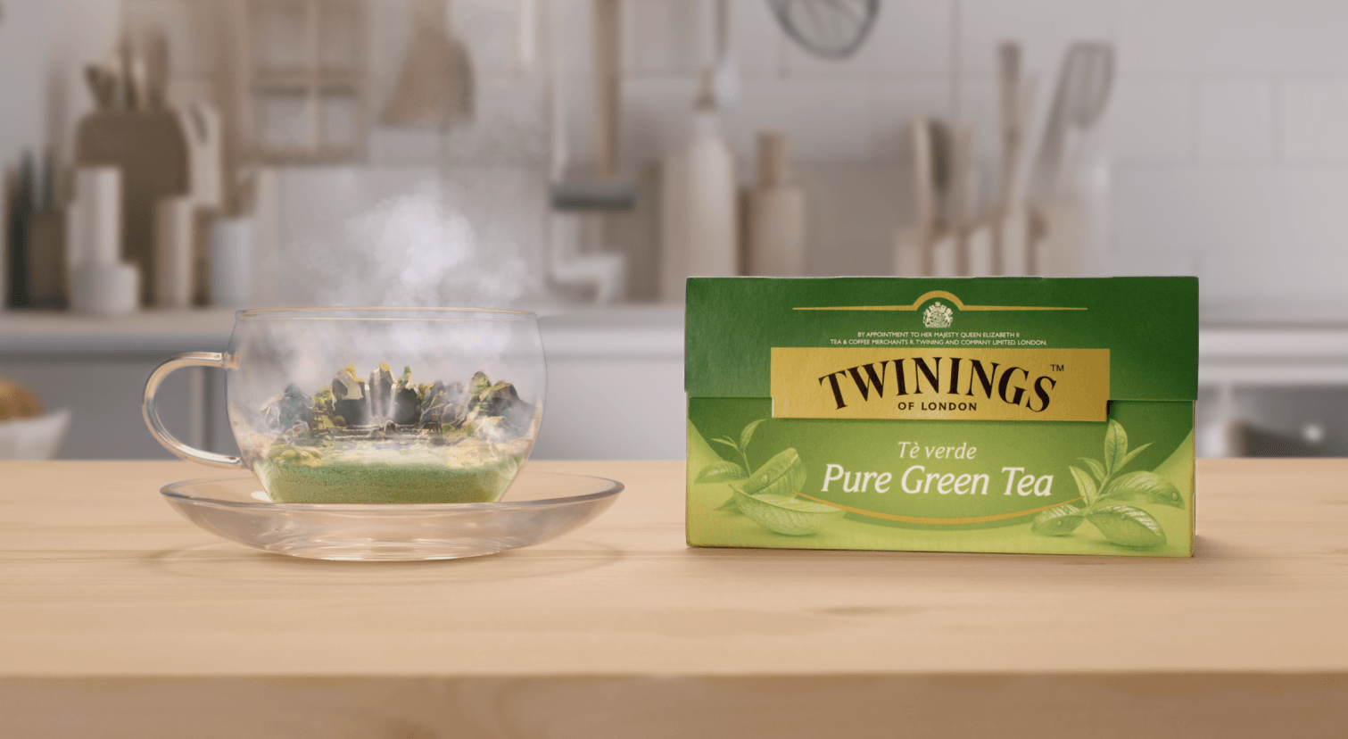 The packaging of Twinings' Pure Green Tea, next to a cup of infused tea.